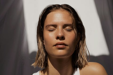 Woman with eyes closed and calm, clear skin
