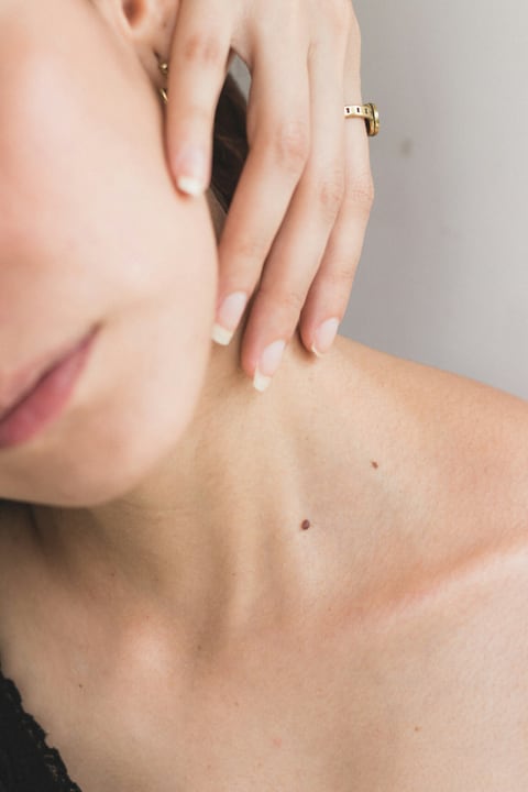 Close-up of the neck and collarbone with small skin marks